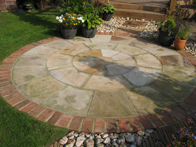 Natural Sandstone circle with brick edging